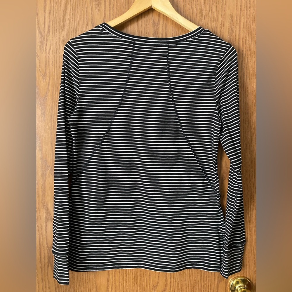 Striped athletic shirt. This sleeve does NOT have thumb holes.